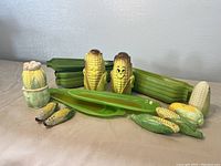 Front view of the entire set showing multiple corn-themed ceramic items arranged on a table.