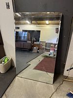 Photo of the rectangular vintage mirror showing reflective surface, beveled edges, and size context in room.