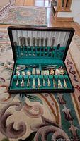 Open case displaying 60-piece cutlery