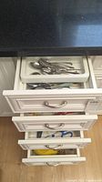 Drawer showing small spoons and miscellaneous flatware