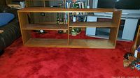 Front view of bookshelf on red carpet