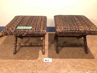 Front view showing two matching square woven rattan stools with dimensions.
