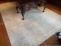 Front view of rug under a desk showing overall color and size relative to floor.