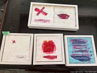 Five encaustic paintings arranged with a double panel piece and four smaller square paintings, featuring abstract red motifs and signed by Rundi Phelan.
