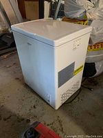 Full view of Koolatron white standup freezer with ventilation grates on side and control panel at bottom.