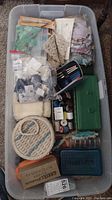 Full view of the sewing and crocheting tools and notions inside a plastic bin.