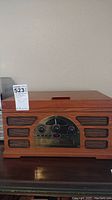 Front view of wooden Crosley stereo system showing the vintage design with speaker grills and control panel.