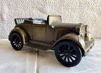 Side view of the bronze-finished 1929 Model T car coin bank showing the key and coin slots.