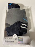 Full view of BMW ladies sports tights shorts inside clear plastic box with label visible