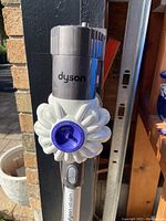 Close-up of cyclone unit and Dyson logo on upper vacuum body