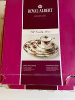 Photo of Royal Albert Old Country Roses branding and product image on box showing 5-piece place setting.