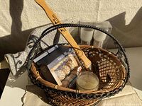 Wicker basket filled with lemon candle, foot roller, back scratcher, bottle opener, tea light holders