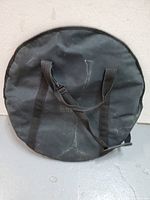 Front view of black cymbal bag, showing wear and carrying handles.