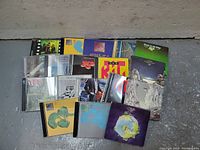 Front view of all Yes CDs laid out showing album cover art
