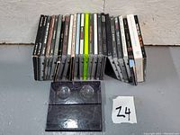 Photo showing fronts and spines of the 19 CDs, with various 1990s rock and alternative bands' albums.