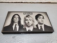 Closed front view of the Nirvana CD box set featuring band members' black and white photo on cover.