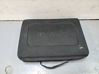 Closed Shure branded carrying case, showing soft-sided black material with slight wear and handle on top.