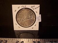 Reverse side showing Voyageur canoe design and 1965 date.