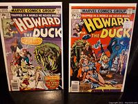 Front cover of Howard the Duck issue #22 and #23 comic books side by side in protective sleeves, showing cover art and pricing details.