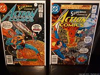 Two Superman Action Comics issues #528 and #529 shown together with full cover art visible in protective sleeves.