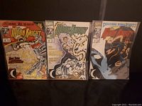 Photo of 3 Moon Knight comics showing covers of issues 42, 48, and 49 with varying cover art and condition.