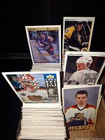 Stack of hockey cards with Wayne Gretzky, Mario Lemieux, Milan Tichy cards visible on top, showing condition and style