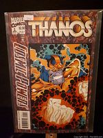 Front cover showing Thanos in orange and purple armor with clenched fists and colorful cosmic background.