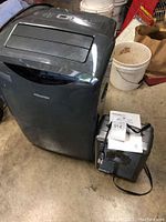 View of Hisense portable air conditioner and HomeBasix portable heater side by side