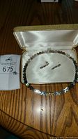 Sterling silver necklace and matching earrings in a jewelry box.