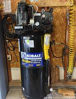 Front view of compressor mounted with attached hoses