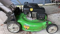 Close-up of the green LawnBoy 20-inch self-propelled lawn mower deck and wheels