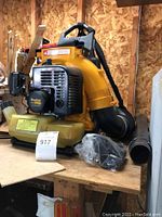 Oblique view of PoulanPro gas blower showing the yellow housing, black motor casing with PoulanPro branding, and shoulder straps.