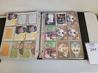 Photo showing hockey cards with gold/bronze coins in plastic binder sleeves, including goalie cards and inserts.