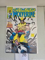 Front cover photo of Marvel Comics Presents Wolverine #118 comic book in protective plastic sleeve showing art of Wolverine with claws extended and black marker scribbles on sleeve.