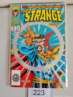 Front cover of Marvel Dr. Strange Sorcerer Supreme #50 comic book in protective sleeve showing hologram foil and main character Dr. Strange casting a spell.