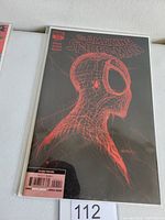 Comic book titled The Amazing Spider-Man #55, featuring a black cover with red sketch design of Spider-Man's head, inside a clear protective sleeve.