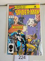 Front cover of Marvel's Web of Spider-Man issue 29 comic book featuring Wolverine in multiple poses alongside Spider-Man in black costume.