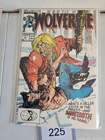 Front cover of the Wolverine #10 comic book showing Sabretooth attacking Wolverine in a snowy forest.