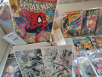 Photo showing comic books including Spider-Man #1, Adventures of Superman, and multiple other key issues laid flat and in protective sleeves.