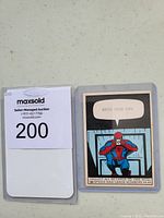 Front of the vintage 1966 Marvel Spider-Man card #36 showing Spider-Man in a comic panel with a speech bubble saying 'WRITE YOUR OWN'.