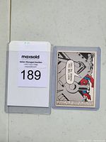 Front of 1966 Marvel Spider-Man card #35 showing Spider-Man image and bold colors, in plastic sleeve with auction lot label.