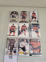 Photo showing the fronts of 9 different Connor McDavid hockey cards, each with unique images and design styles.
