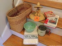 View of entire lot showing step basket, Fire King Jadeite bowl, vintage sifter, and textile.