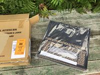 Photo of the three soft-sided storage bins in leopard print and black color, new in box with packaging visible.