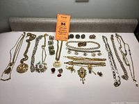 Full lot overview showing pin, cuff links, necklace chains and medallions