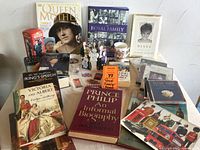 Overview of collection including books, DVDs, CDs, paper figurines, and memorabilia arranged on table.