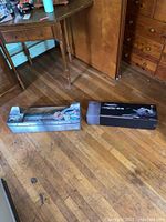 Overview of two boxed models on wooden floor, showing P-51D and F-15E packaging