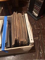 Box containing multiple vinyl record sleeves viewed from above