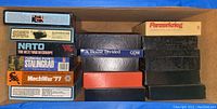 Wide view of game box stacks showing labeled and unlabeled boxes