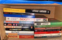 Full stack of board game boxes on wooden shelf under blue tarp